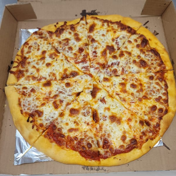 A whole Momo's Pizzeria cheese pizza, cut into eight slices, in a cardboard delivery box.