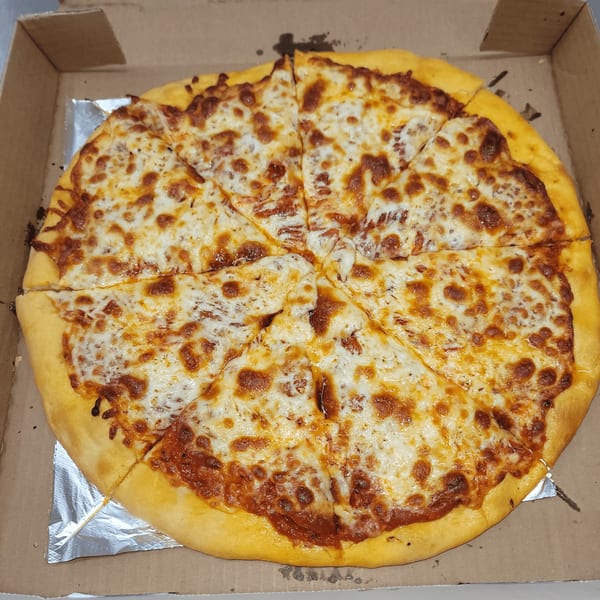 A whole Momo's Pizzeria cheese pizza, cut into eight slices, in a cardboard delivery box.